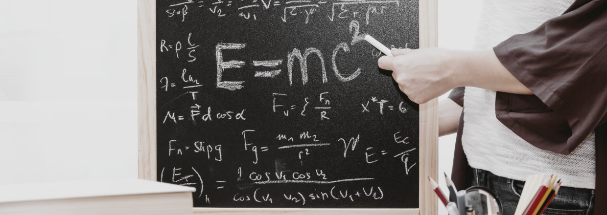 Image of a chalk board with mathematical equations on it
