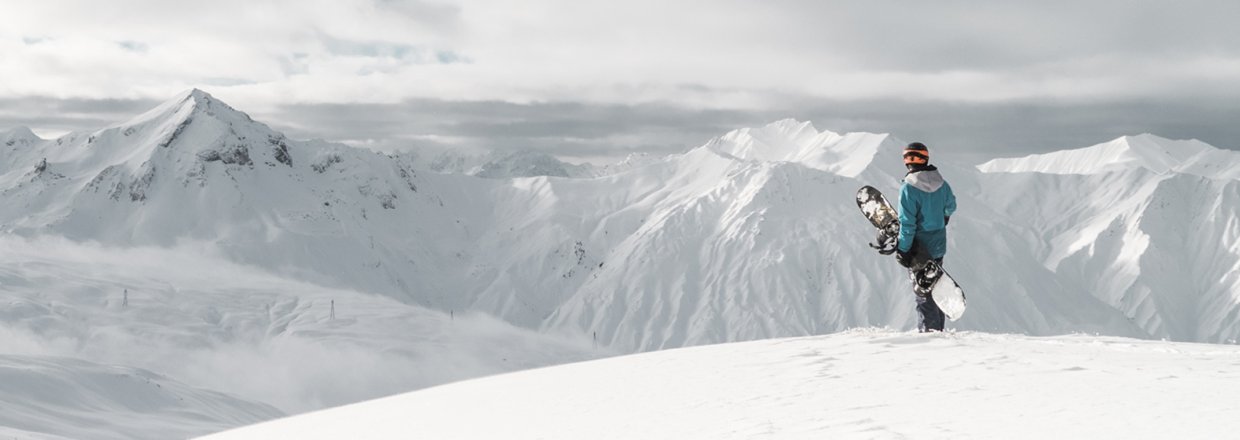 snowboarder staring at the mountains