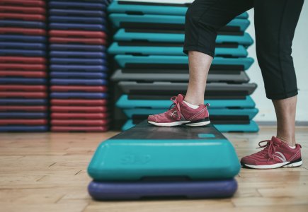 Person stepping up onto a box
