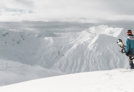 snowboarder staring at the mountains